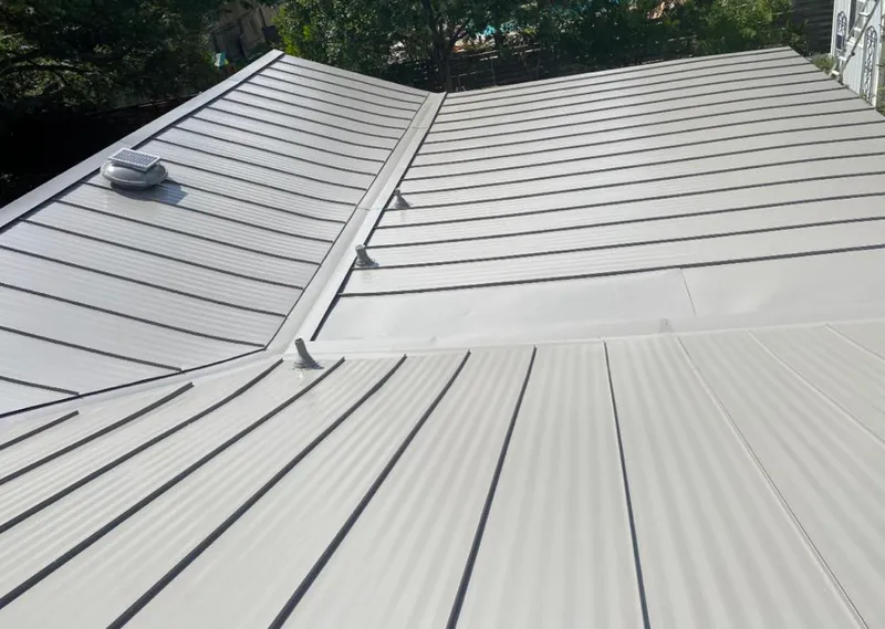 Solar attic fan installed on a metal roof for Roof Ventilation in Yukon